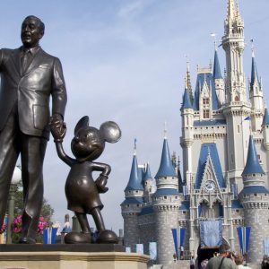 A statue of Walt Disney and Mickey Mouse stands in front of